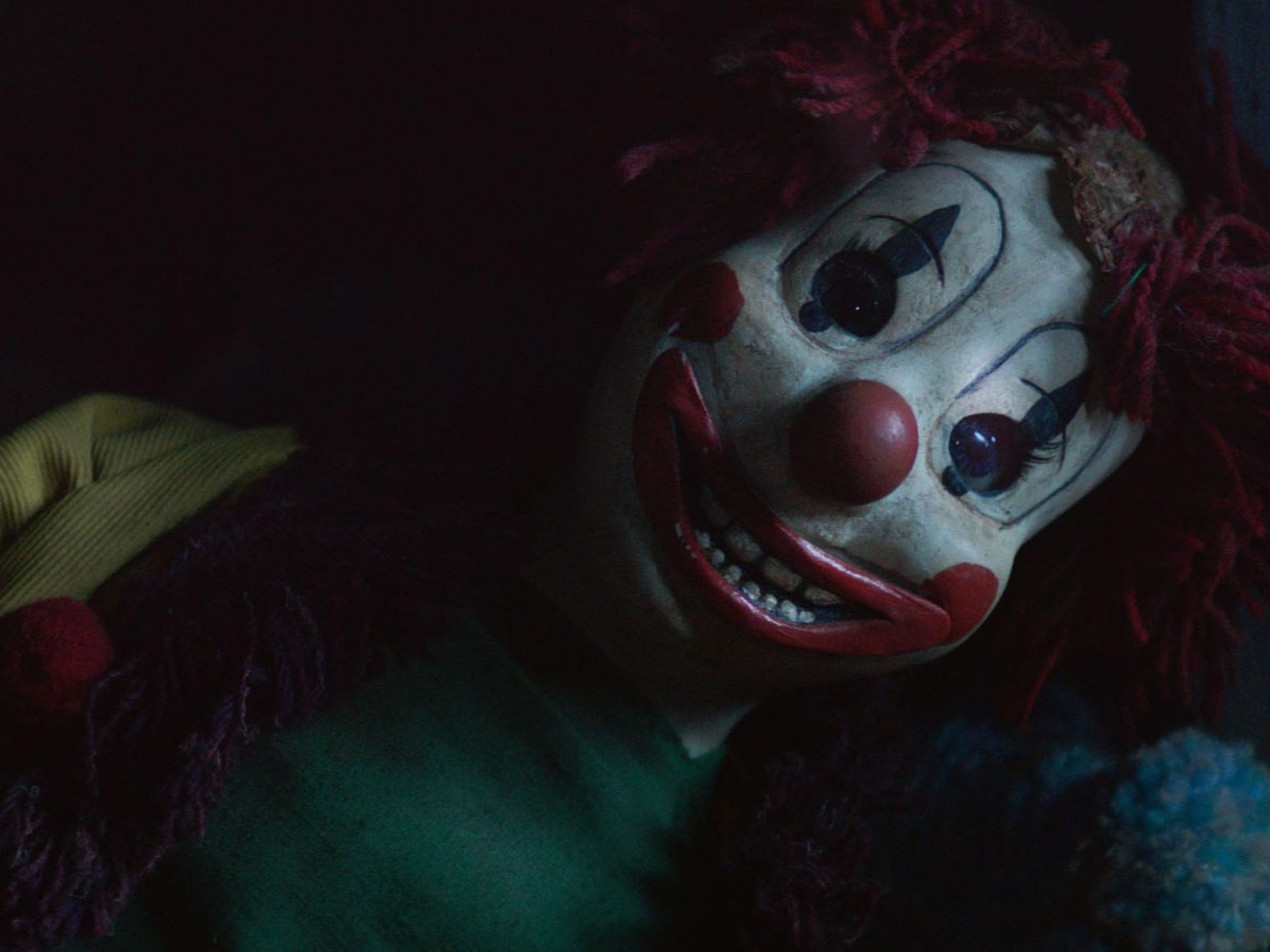 A creepy clown doll with a creepy smile. - Clown