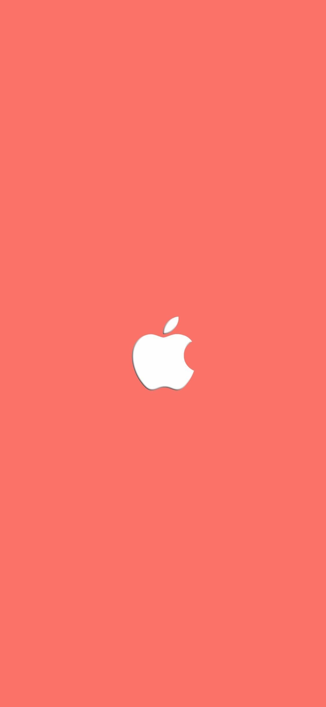 A close up of an apple logo on pink background - Coral