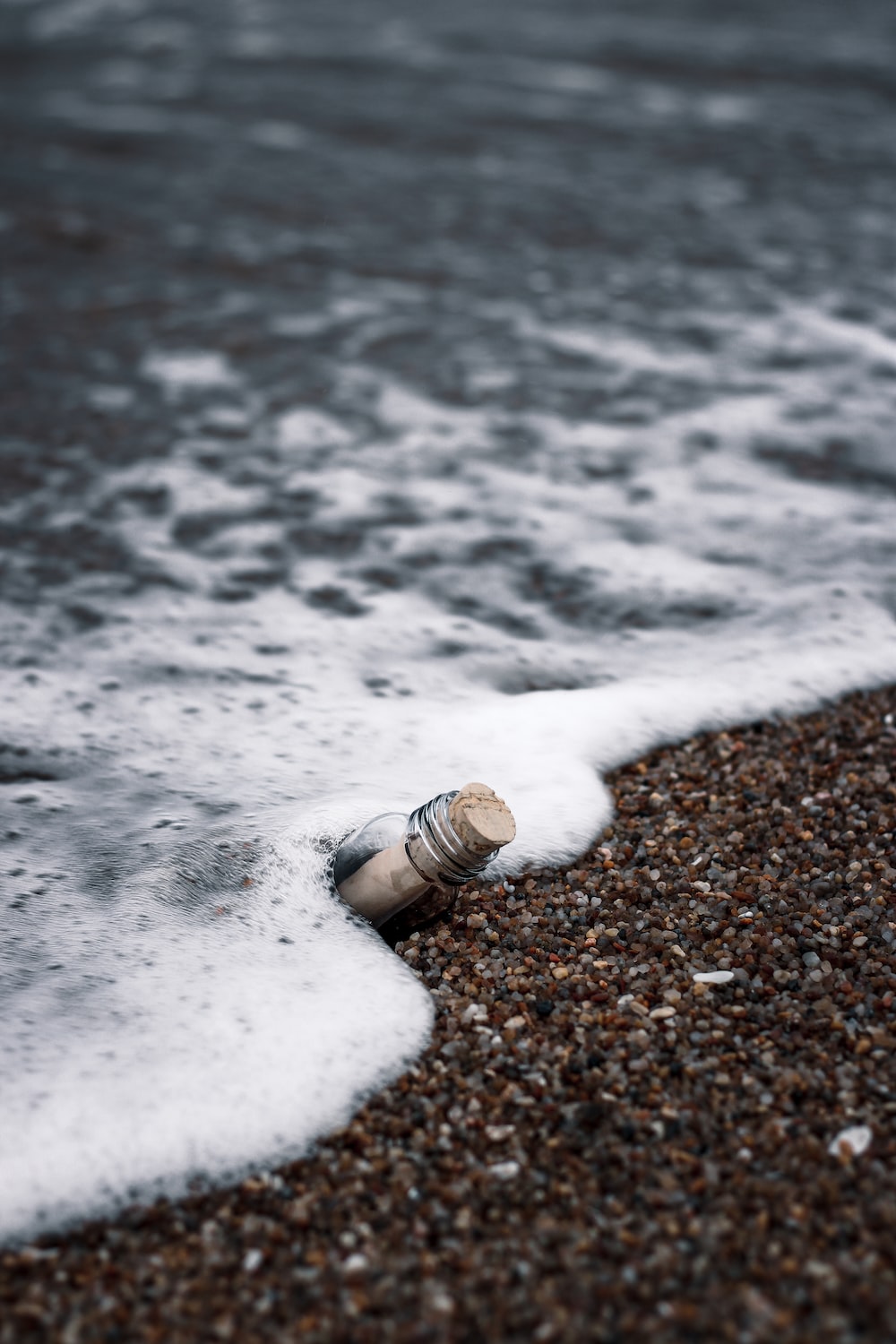 A bottle is laying on the beach - Silver