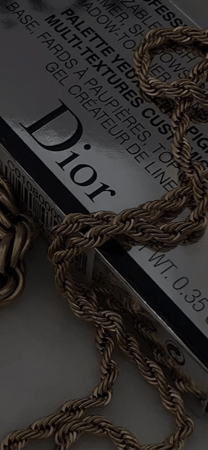 A close up of some gold chains - Dior