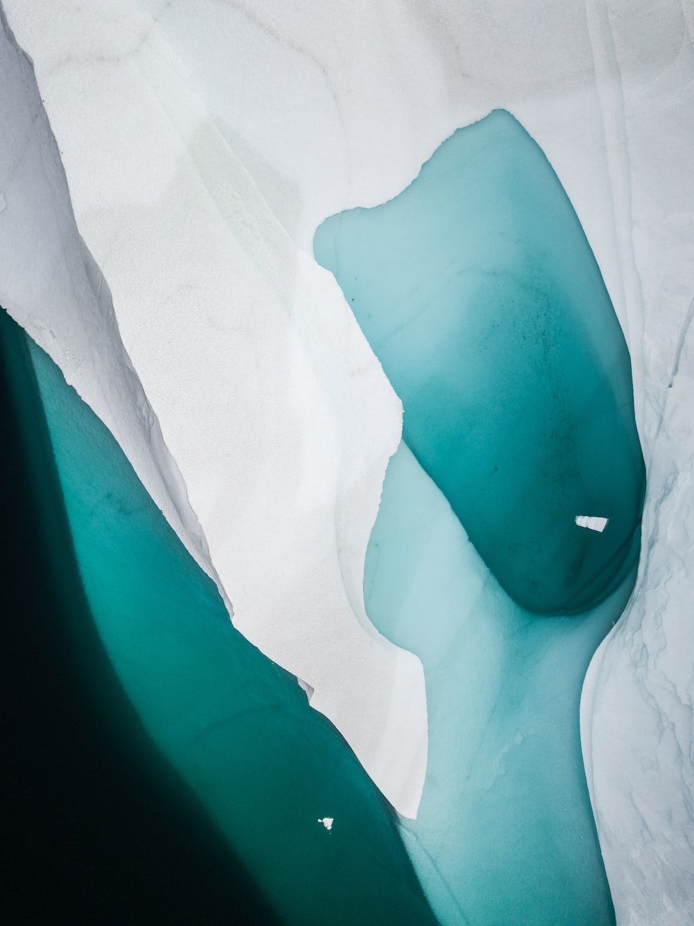A white and blue ice formation in the Arctic - Cyan, turquoise, teal