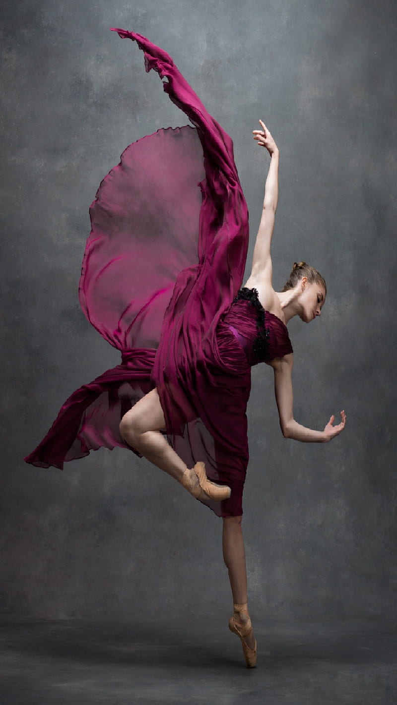 A ballerina in a flowing fuchsia dress leaps into the air. - Ballet