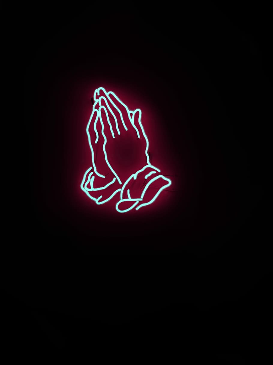 A neon sign of praying hands in red and blue - Drake