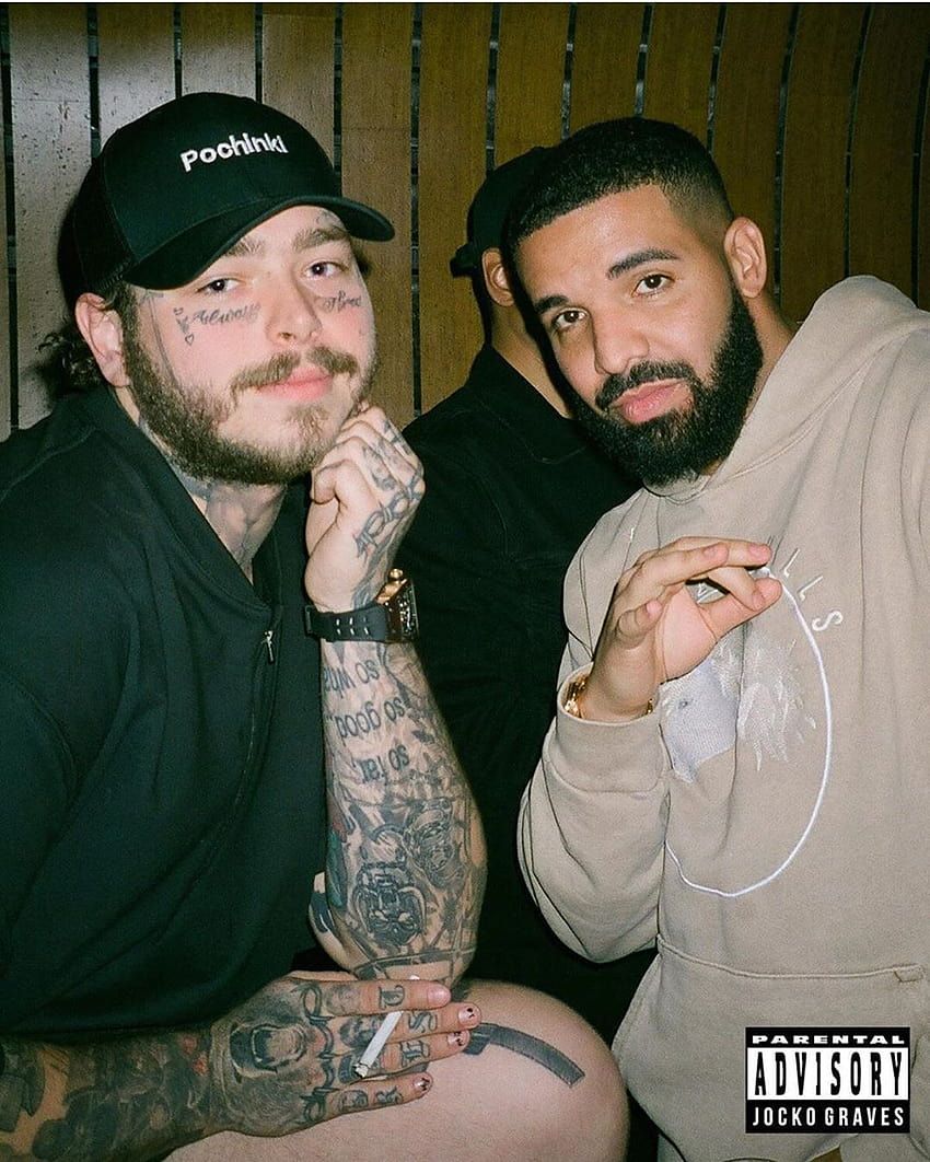 Two men with tattoos and a hat sitting next to each other - Drake