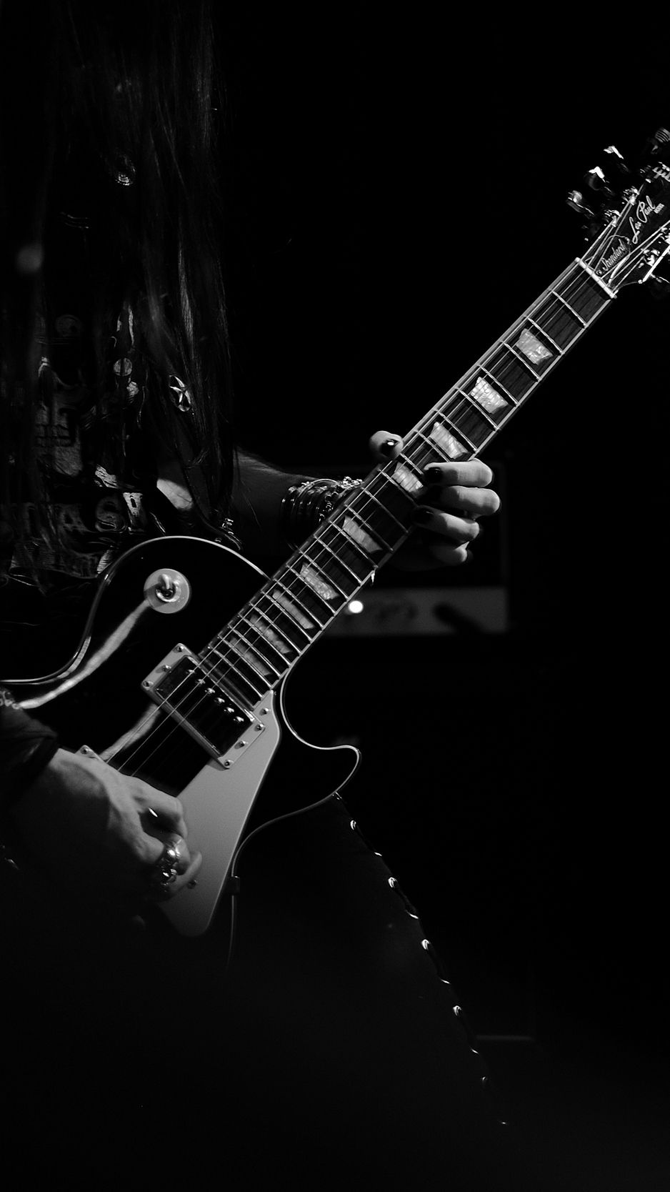 A man playing an electric guitar in black and white. - Guitar