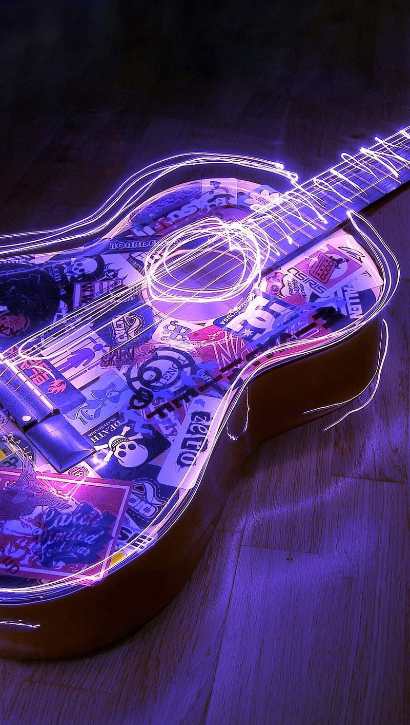 A guitar with stickers and neon lights. - Guitar
