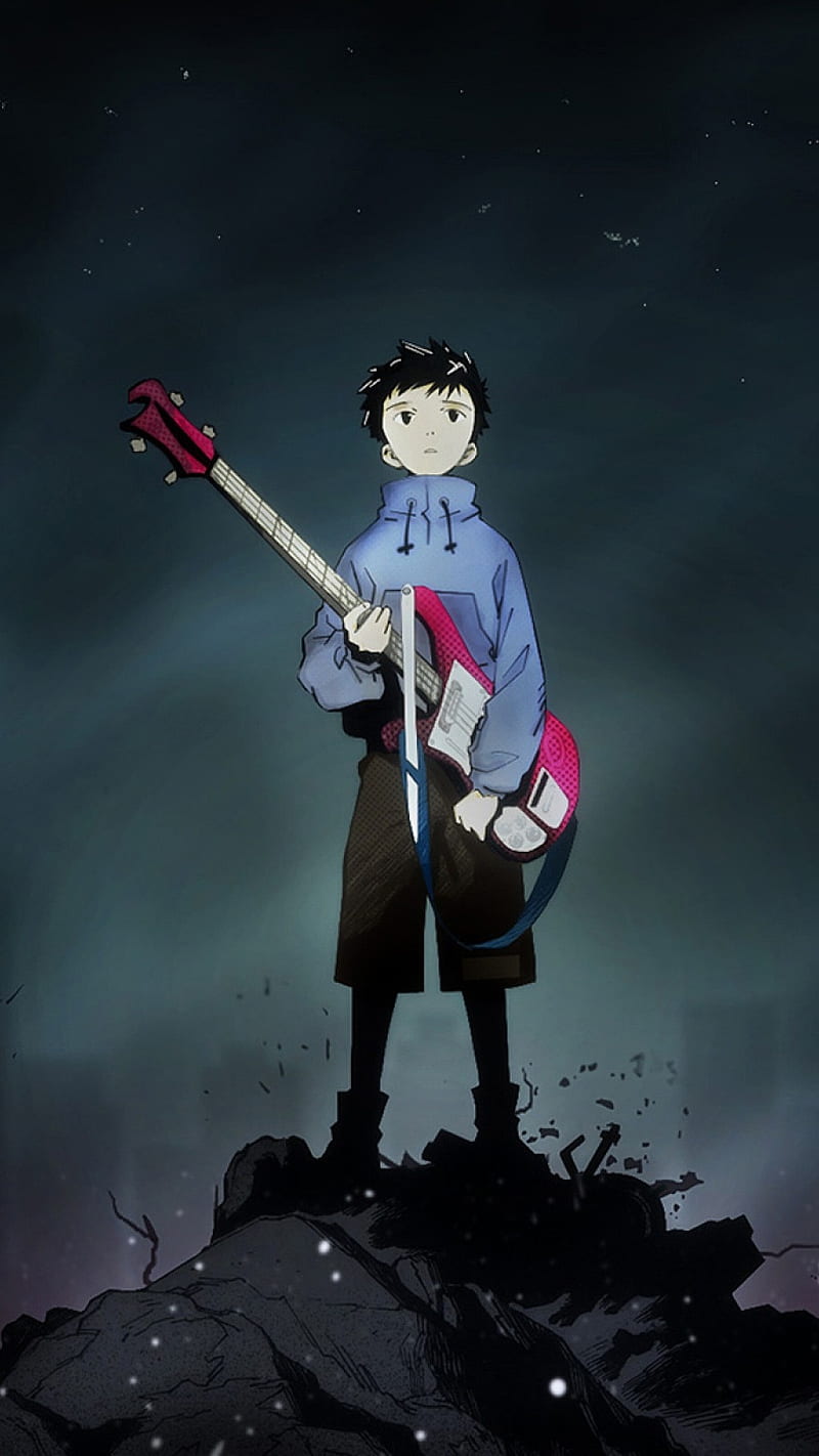 A boy with a guitar standing on a pile of rubble - Guitar