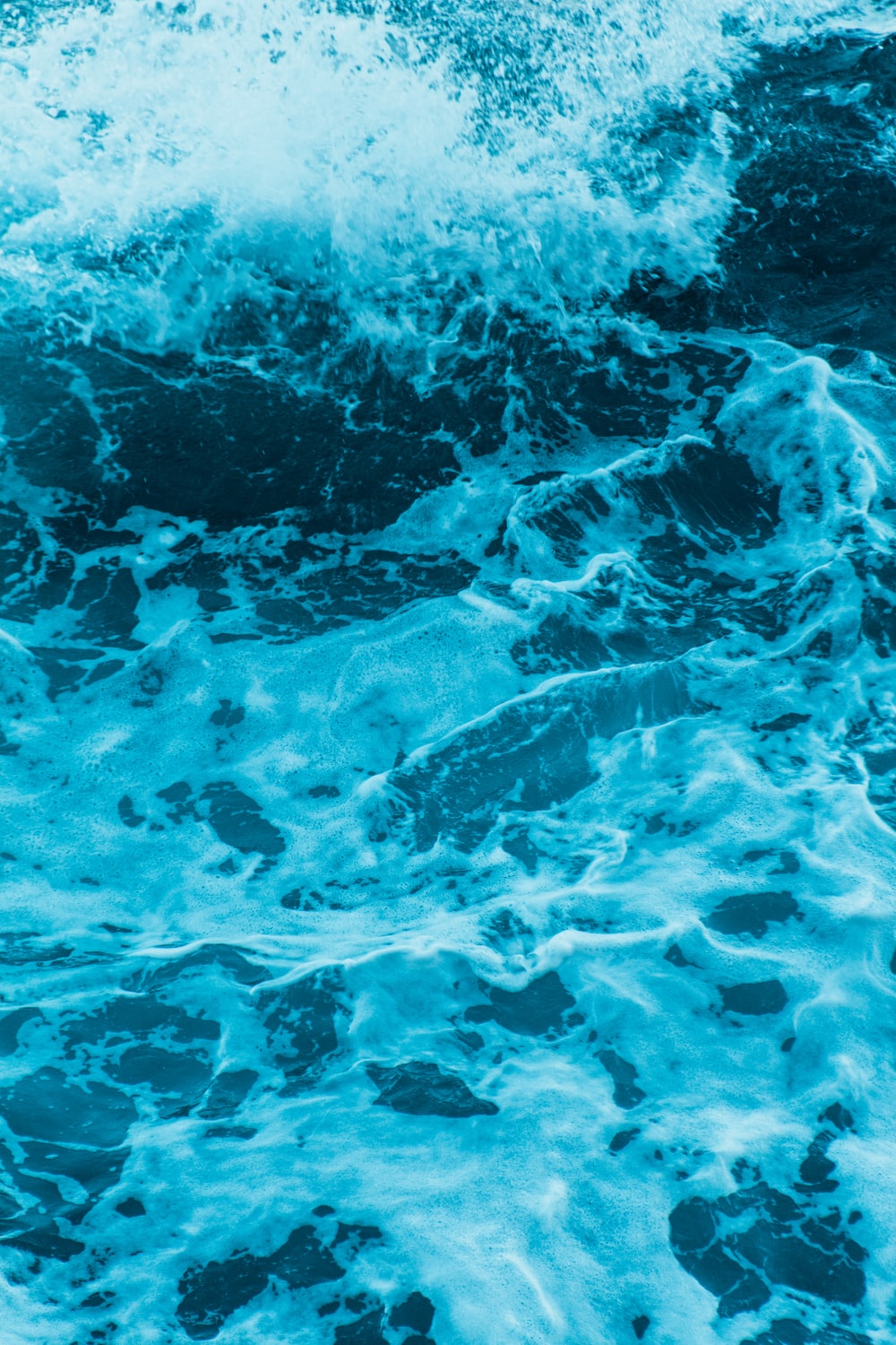 water waves on blue body of water photo