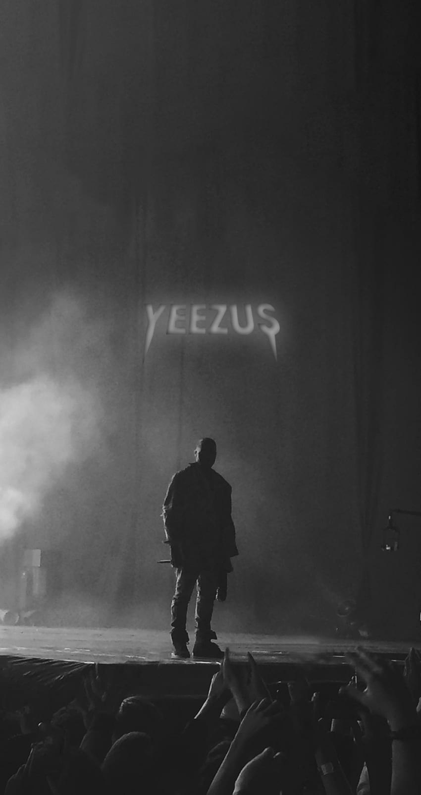 A man standing on stage in front of an audience - Kanye West