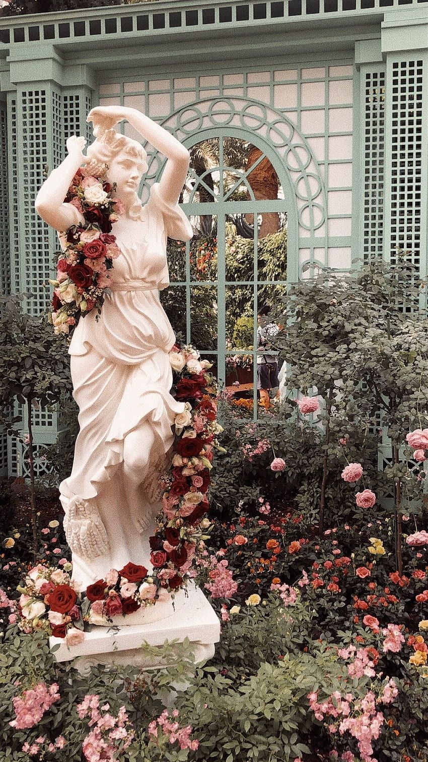 A statue of a woman with flowers in her hair - Garden
