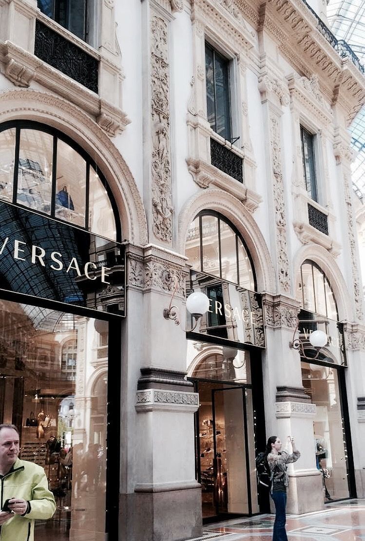 A man is walking in front of the versace store - Fashion, architecture