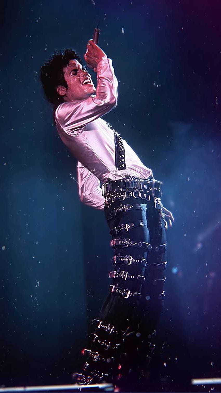 IPhone wallpaper of Michael Jackson performing on stage in a white shirt and black pants. - Michael Jackson