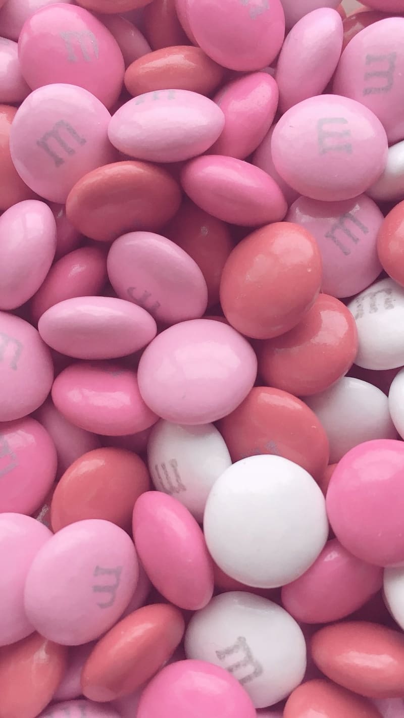 A pile of pink and white M&M's - Candy