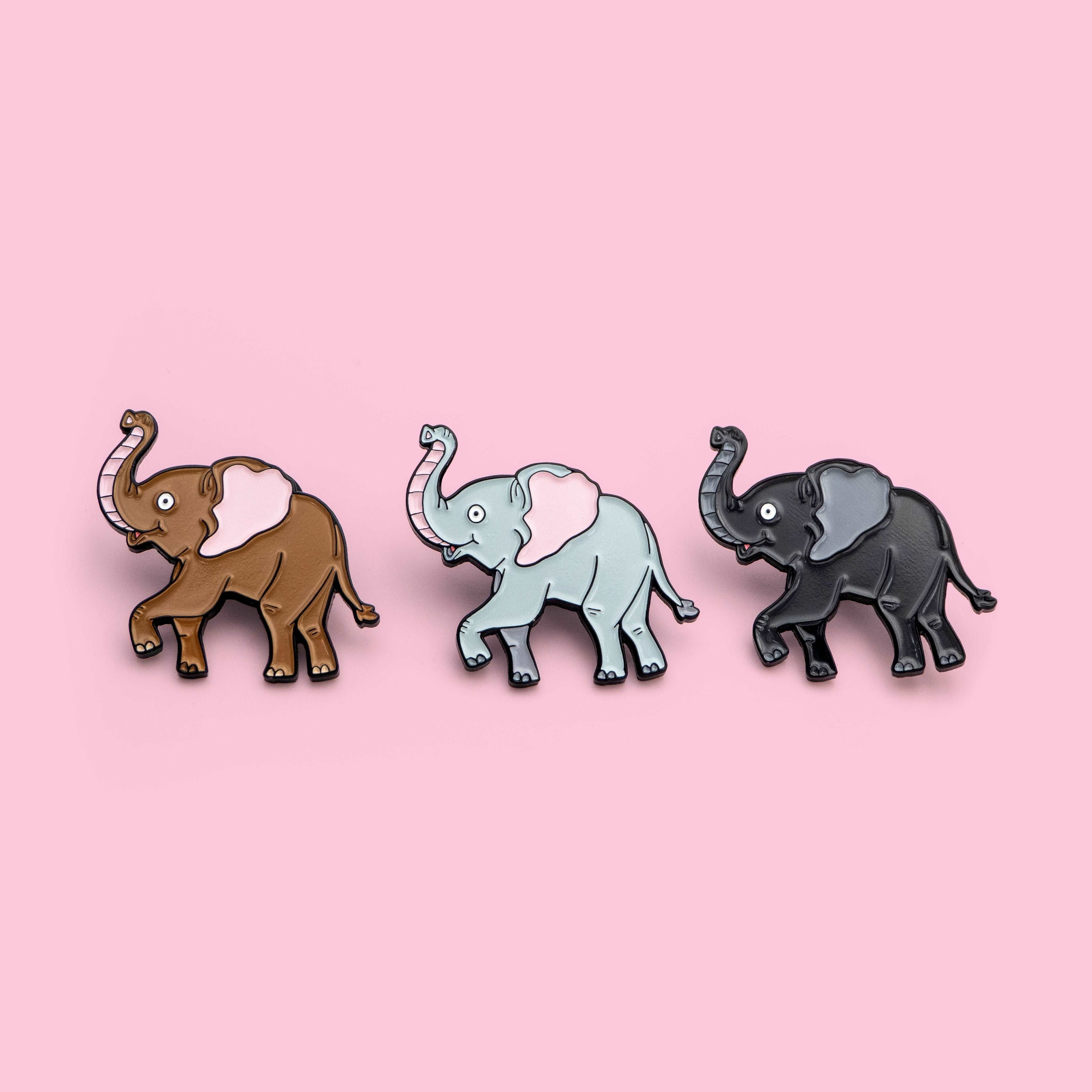 Three enamel pins of cartoon elephants on a pink background - Elephant