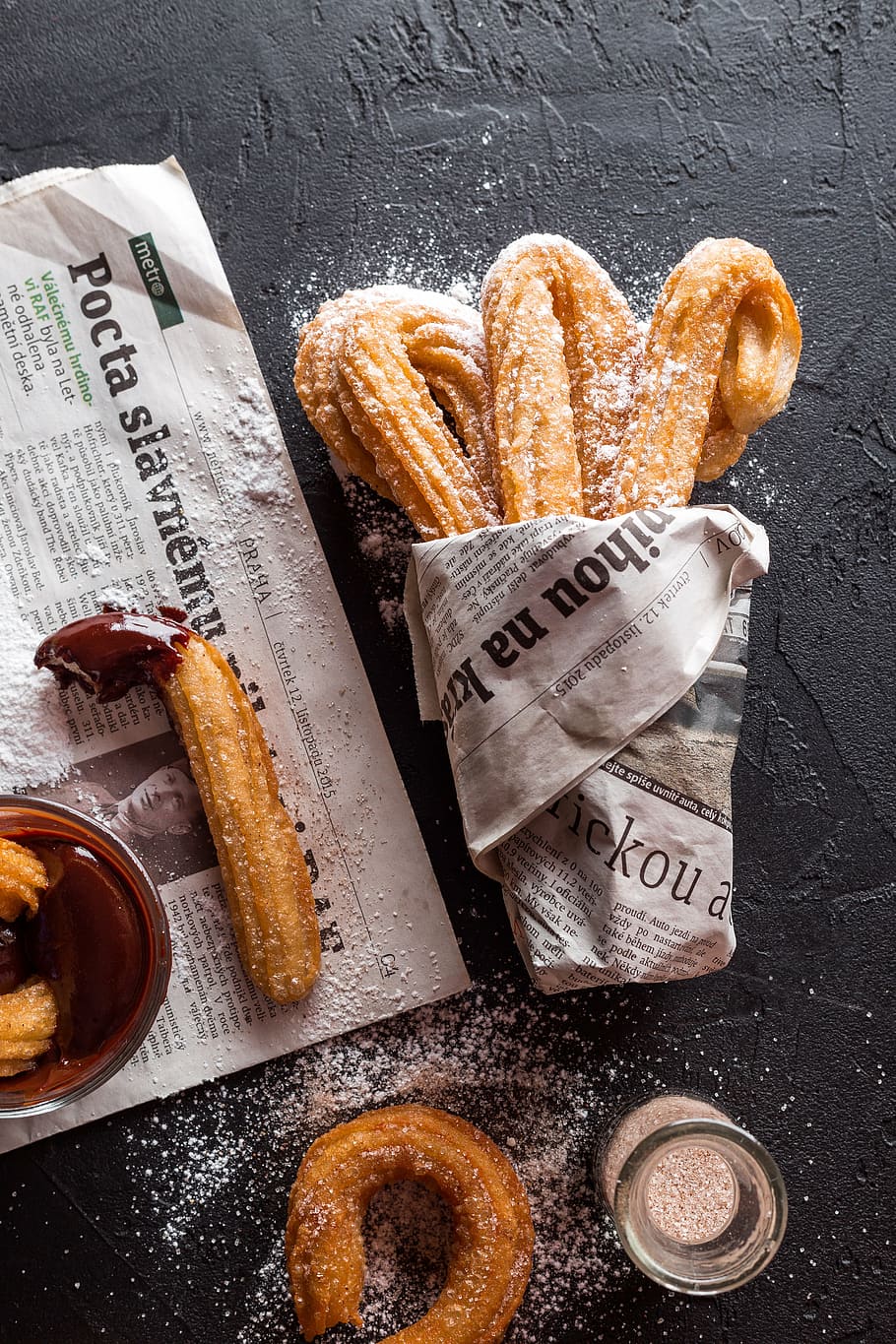 Churros with chocolate dip on a black background - Bakery