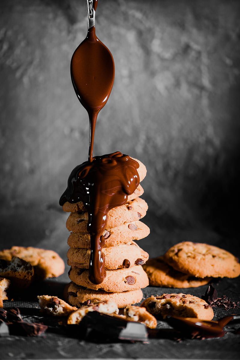 A stack of cookies with chocolate sauce dripping down - Bakery