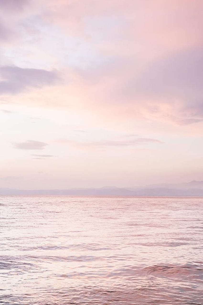 A pink and purple sunset over a calm sea - Blush