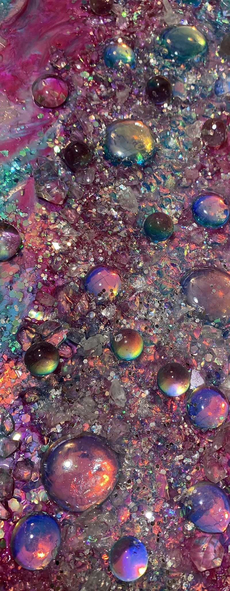 A close up of bubbles and glitter on a dark background. - Bubbles, iridescent