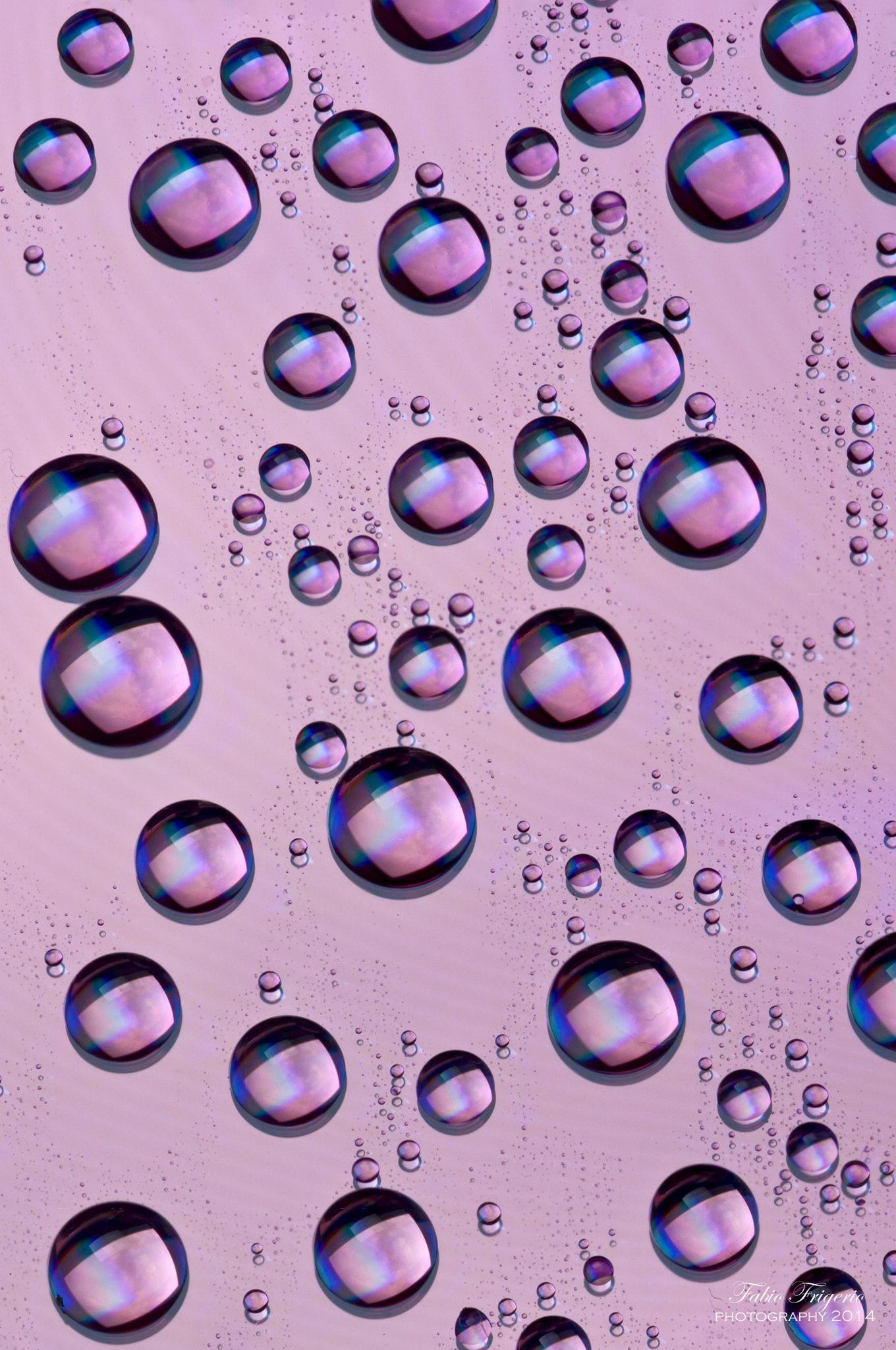 A close up of water droplets on the surface - Bubbles