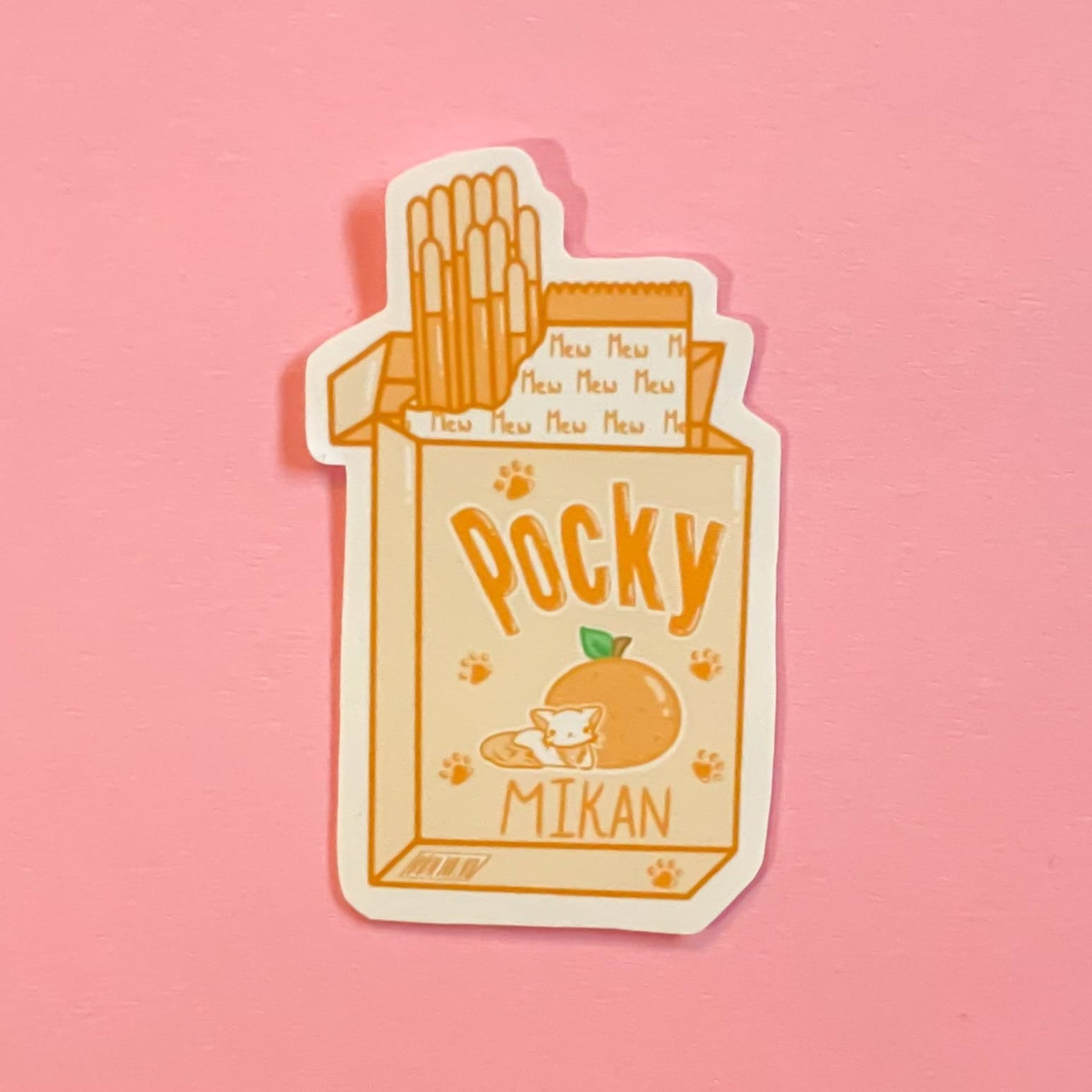 Sticker of a hand holding a pack of pocky with the words 