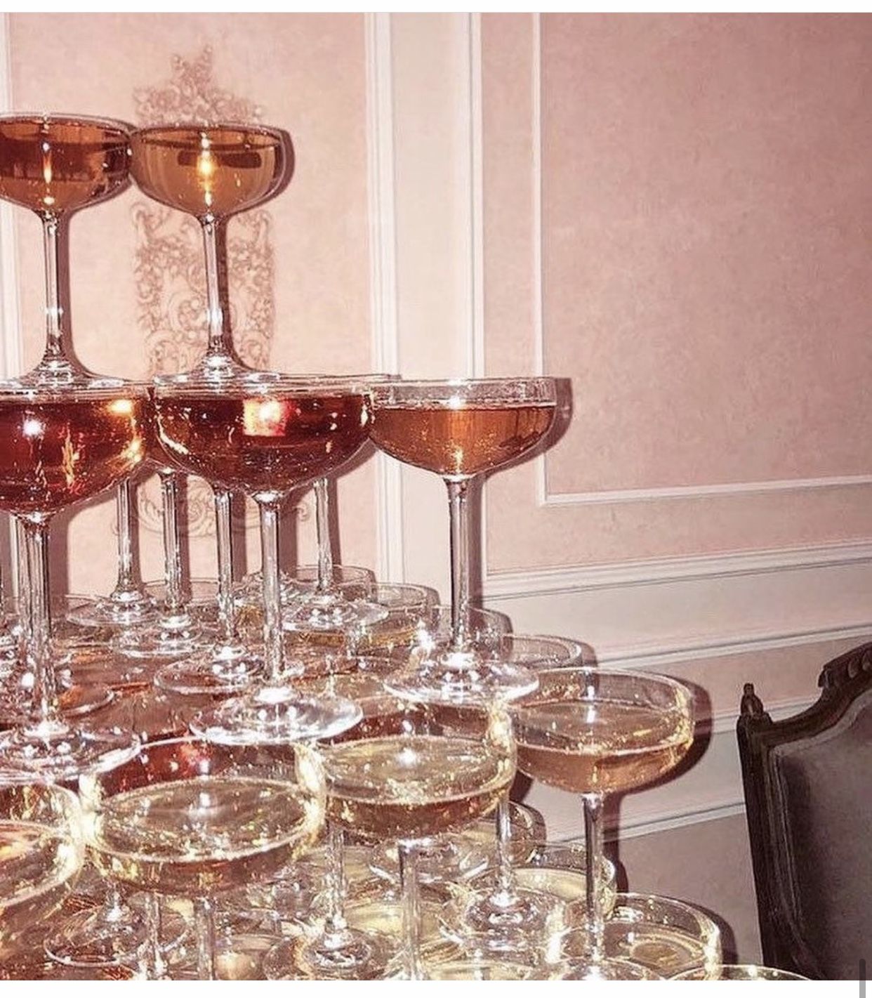 A tower of glasses with wine in them. - Champagne