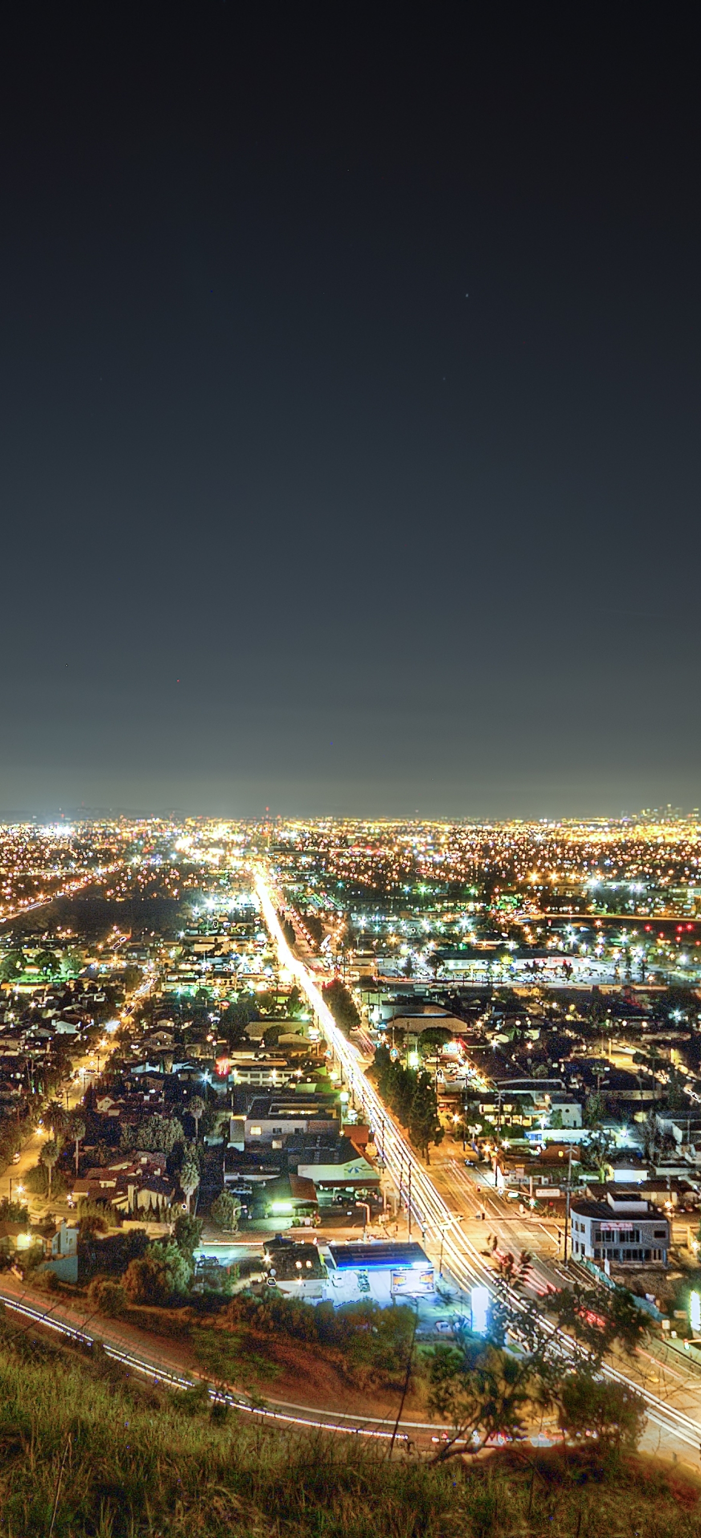 A city at night lit up with lights from the buildings below. - Los Angeles, California