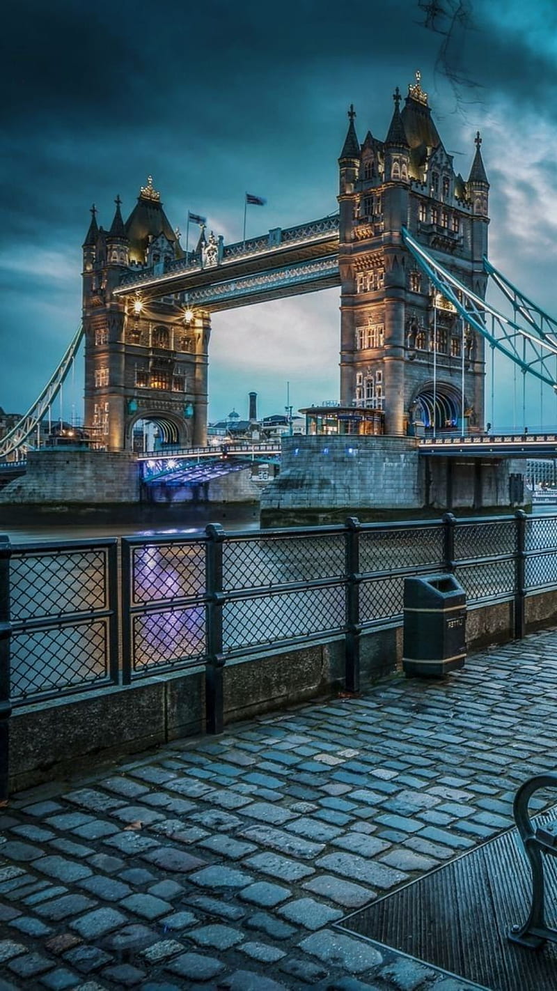 A bench sitting next to the thames river - London