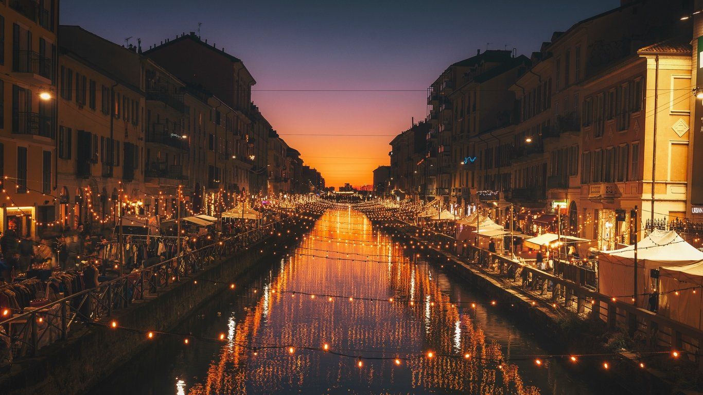 A canal with buildings on either side at night - Italy