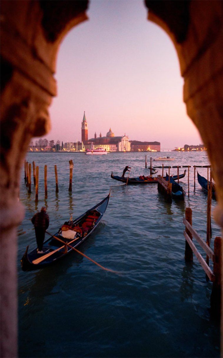 Gondolas docked in the water at sunset in Venice, Italy - Italy