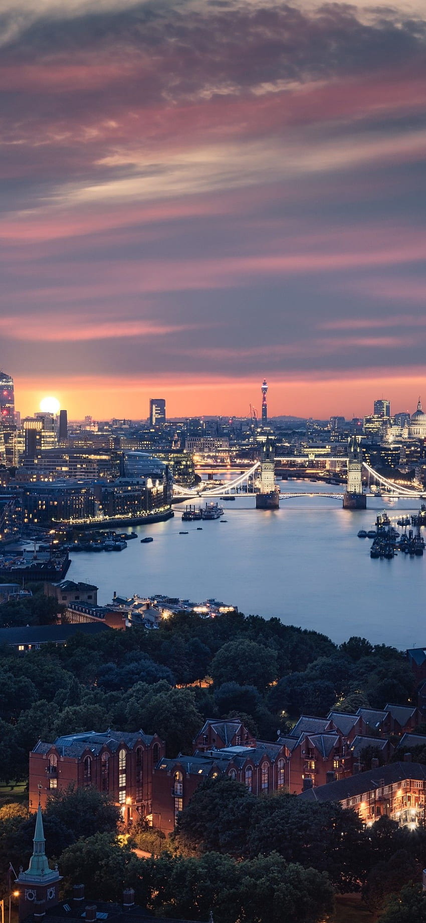 A city skyline at sunset with the water in front - London