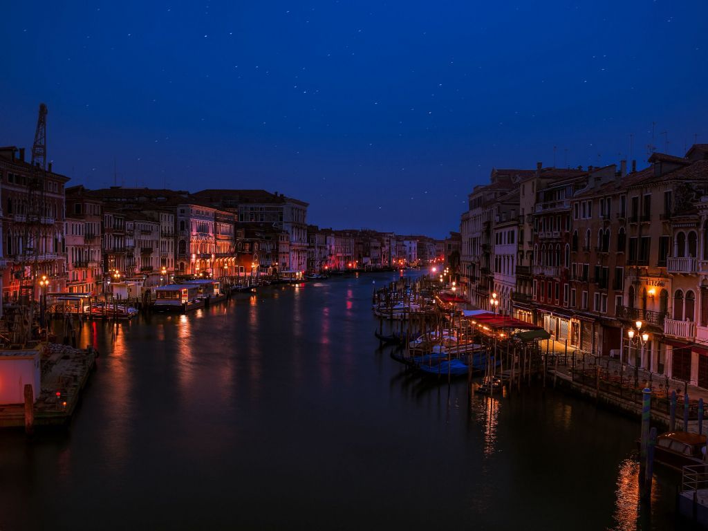 As a city with boats and lights at night - Italy