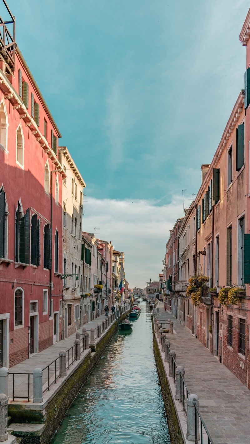 A canal with buildings on either side - Italy