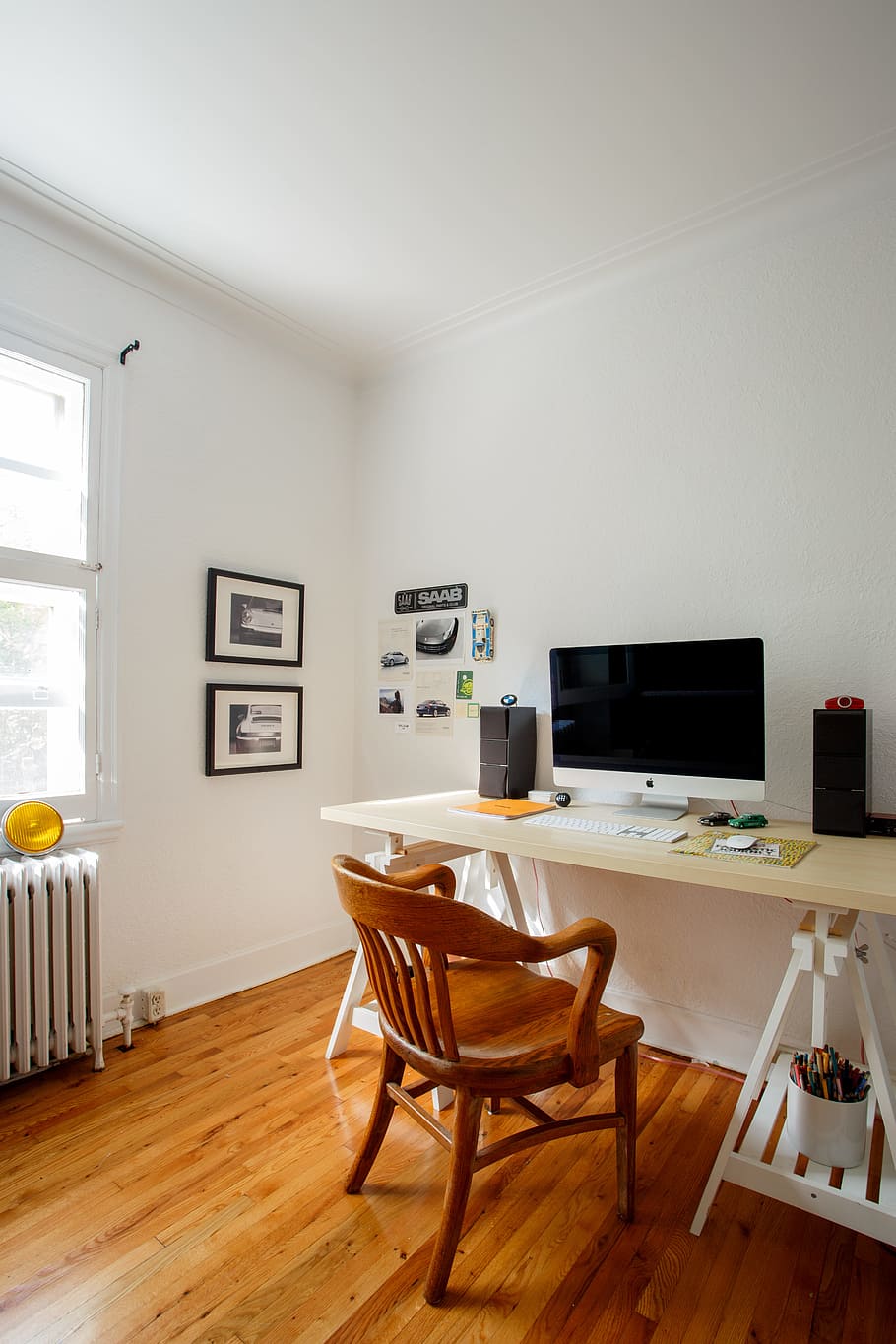 A room with wood floors and white walls - The Office