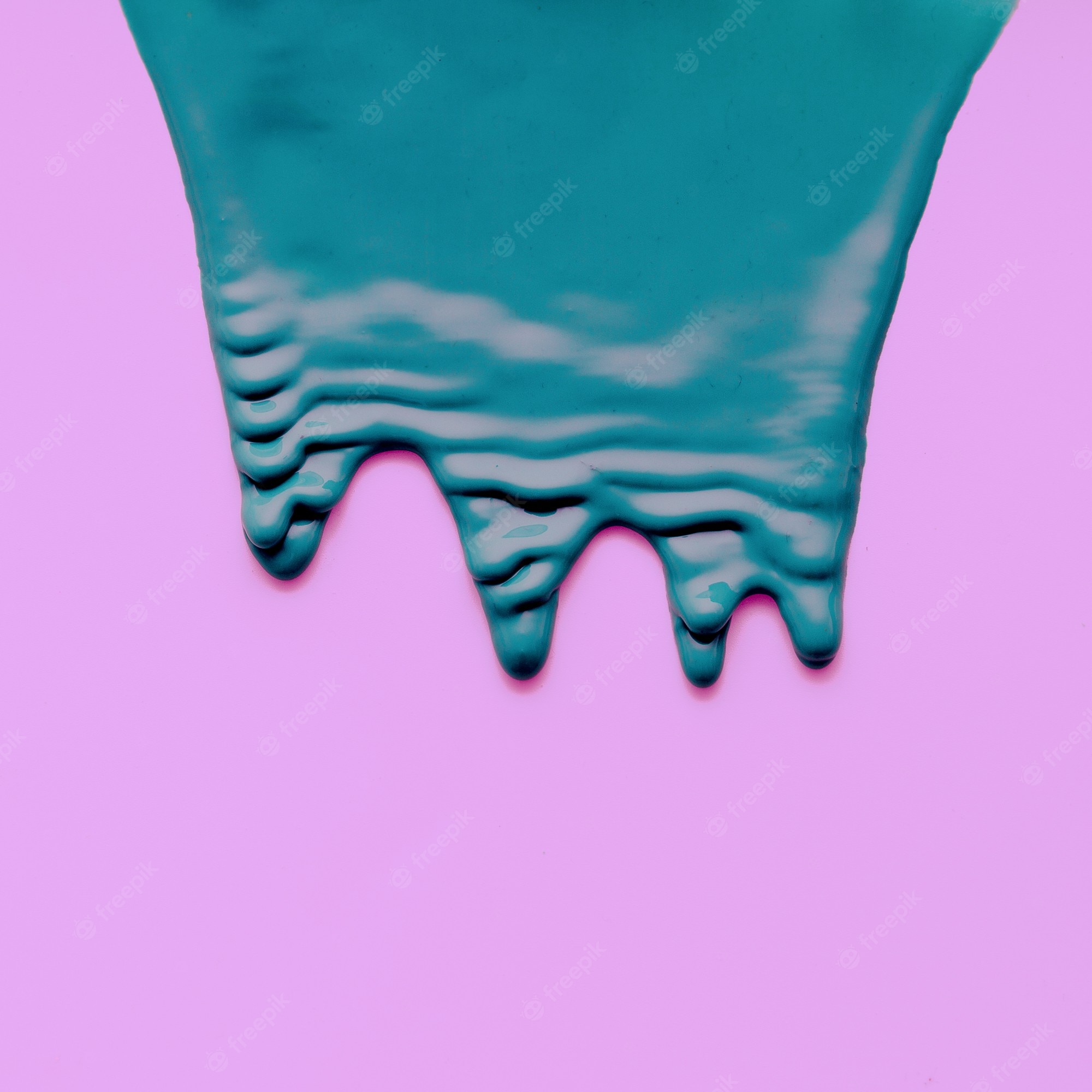 A blue liquid is dripping down onto pink - Slime