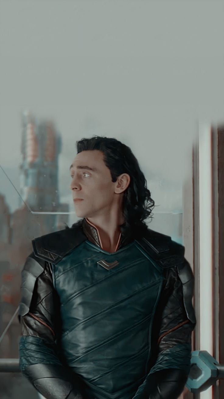 A man in leather jacket standing on the edge of something - Loki