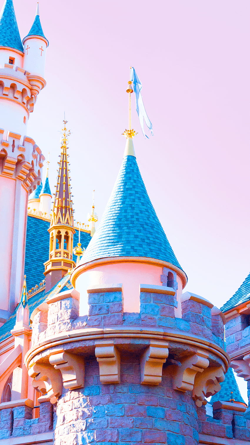 Sleeping Beauty Castle at Disneyland captured in the morning with a pink sky background - Disneyland
