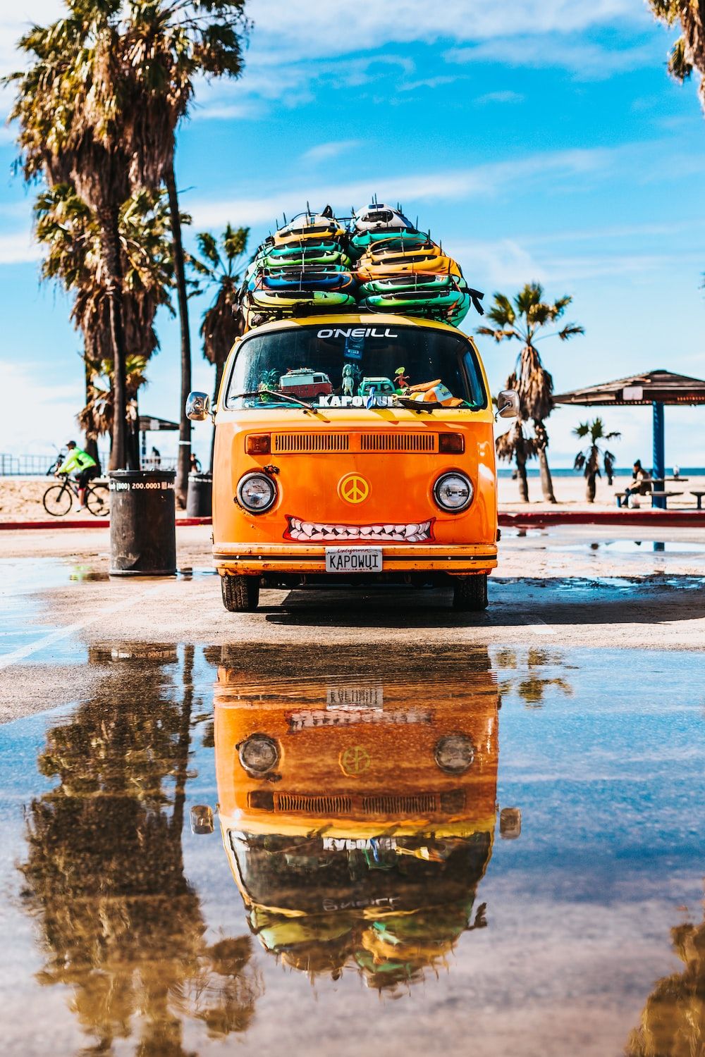 orange van with surfboard on top photo