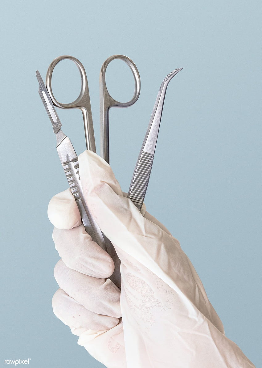 A hand holding surgical instruments in gloves - Dentist