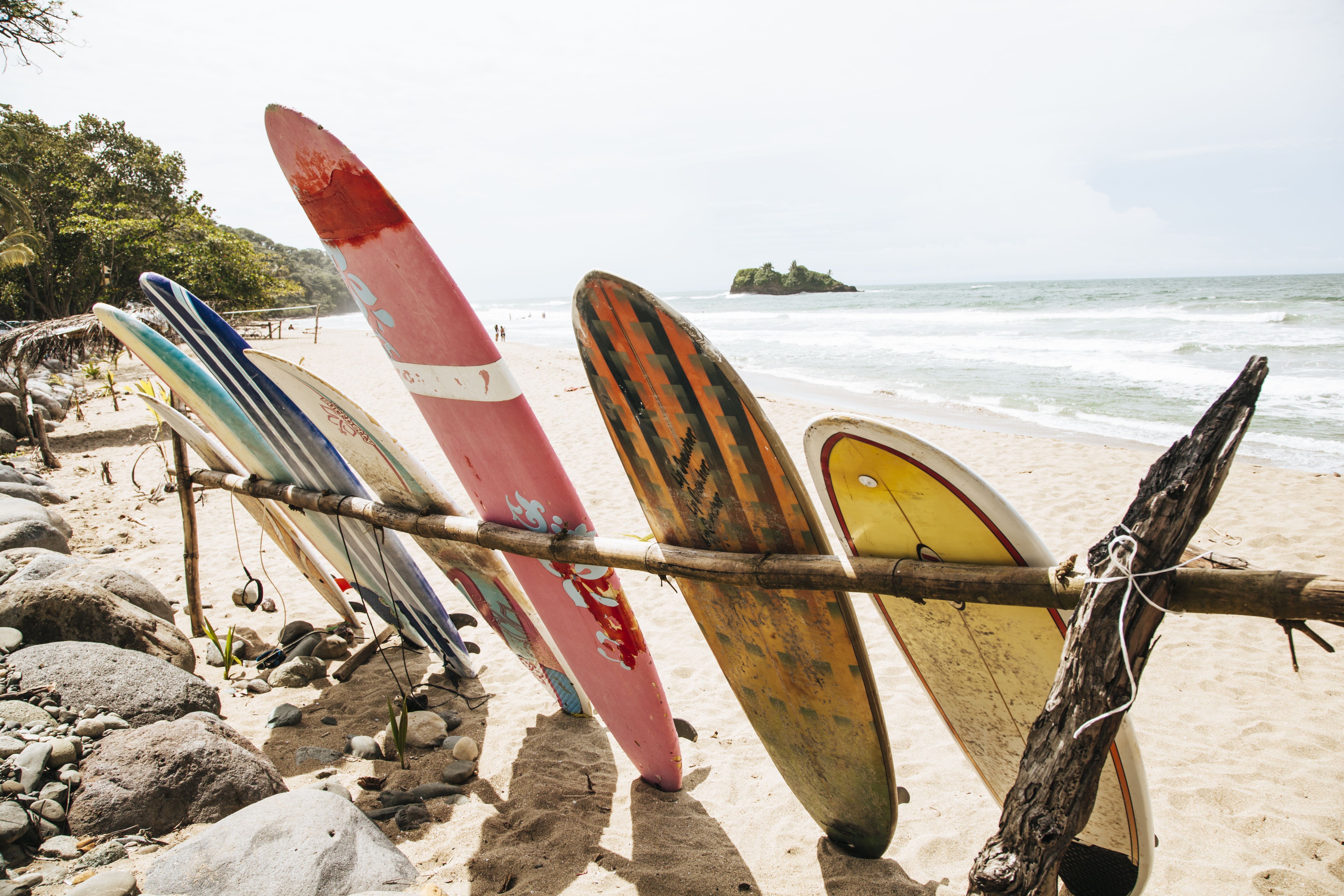 A group of surfboards leaning against the beach - Surf