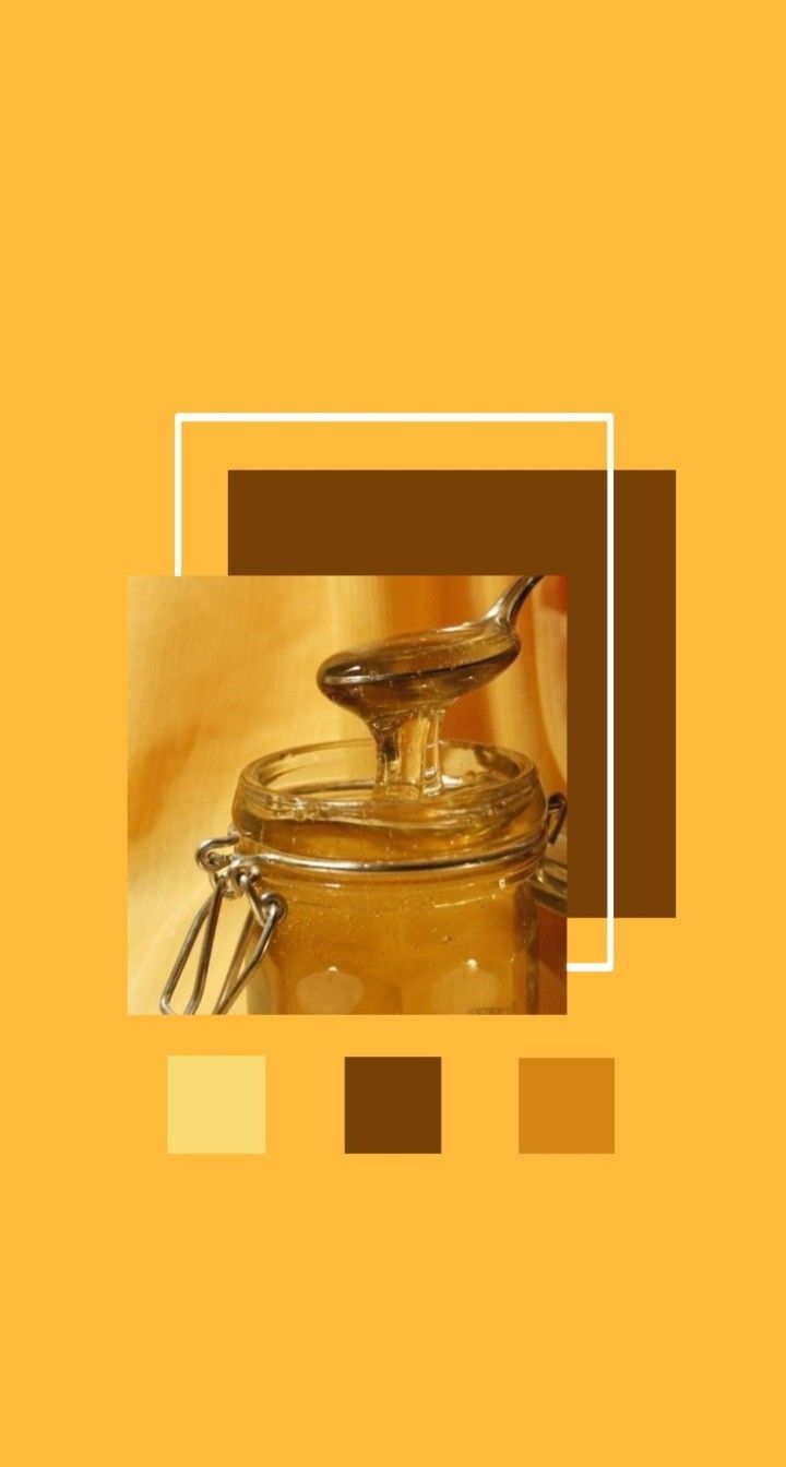 A jar of honey with a spoon in it. - Honey