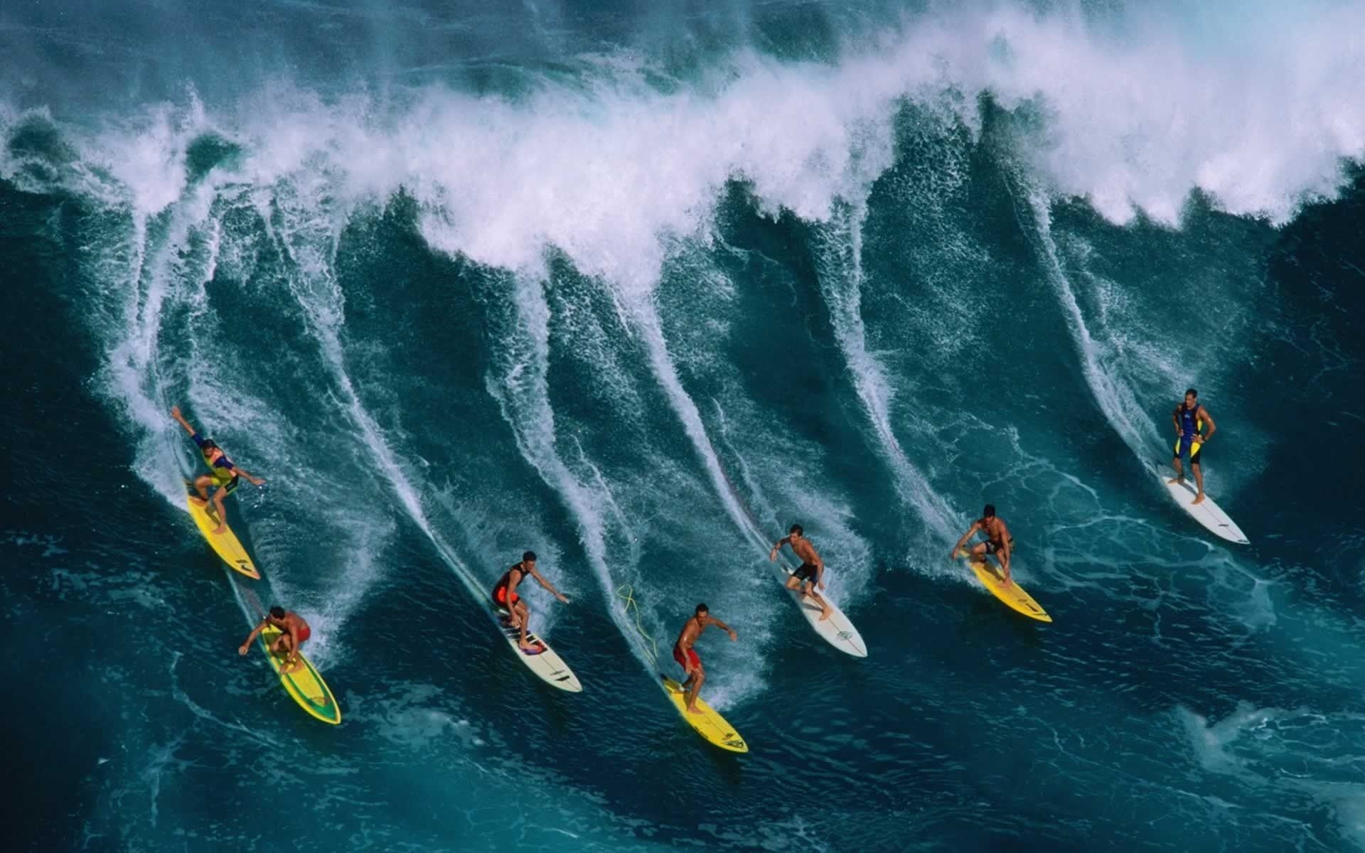 A group of surfers ride a large wave - Surf