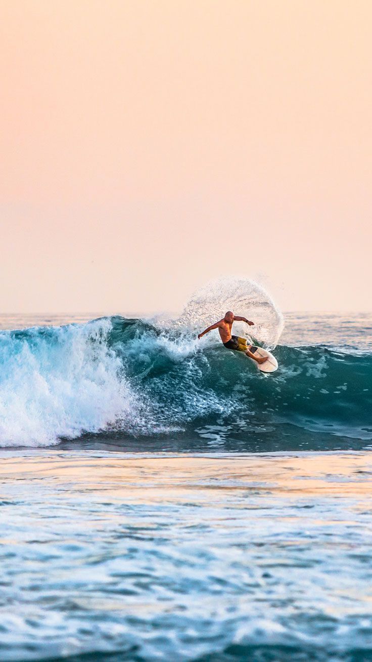 A man riding on top of the waves - Surf