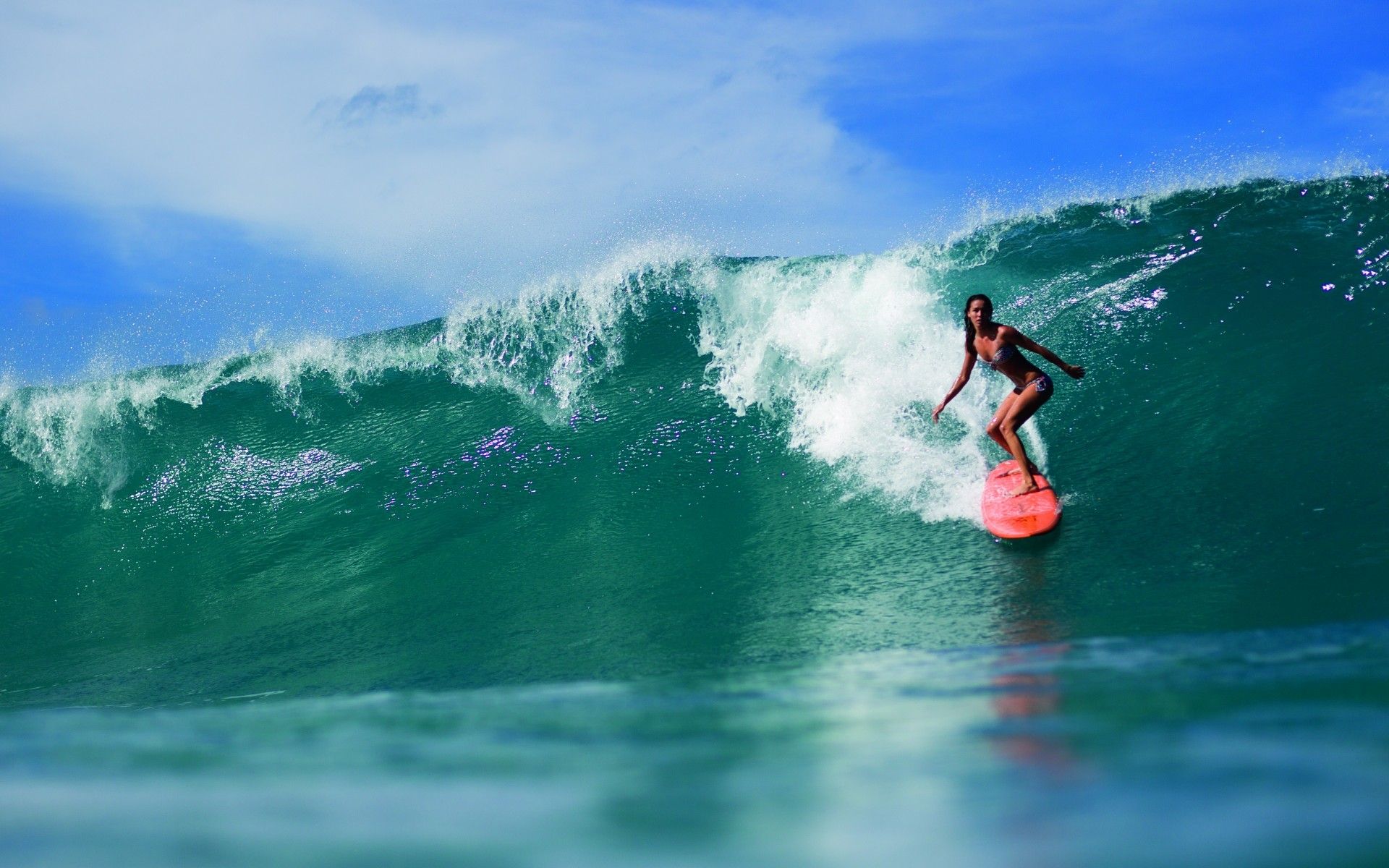 A woman riding on top of an ocean wave - Surf