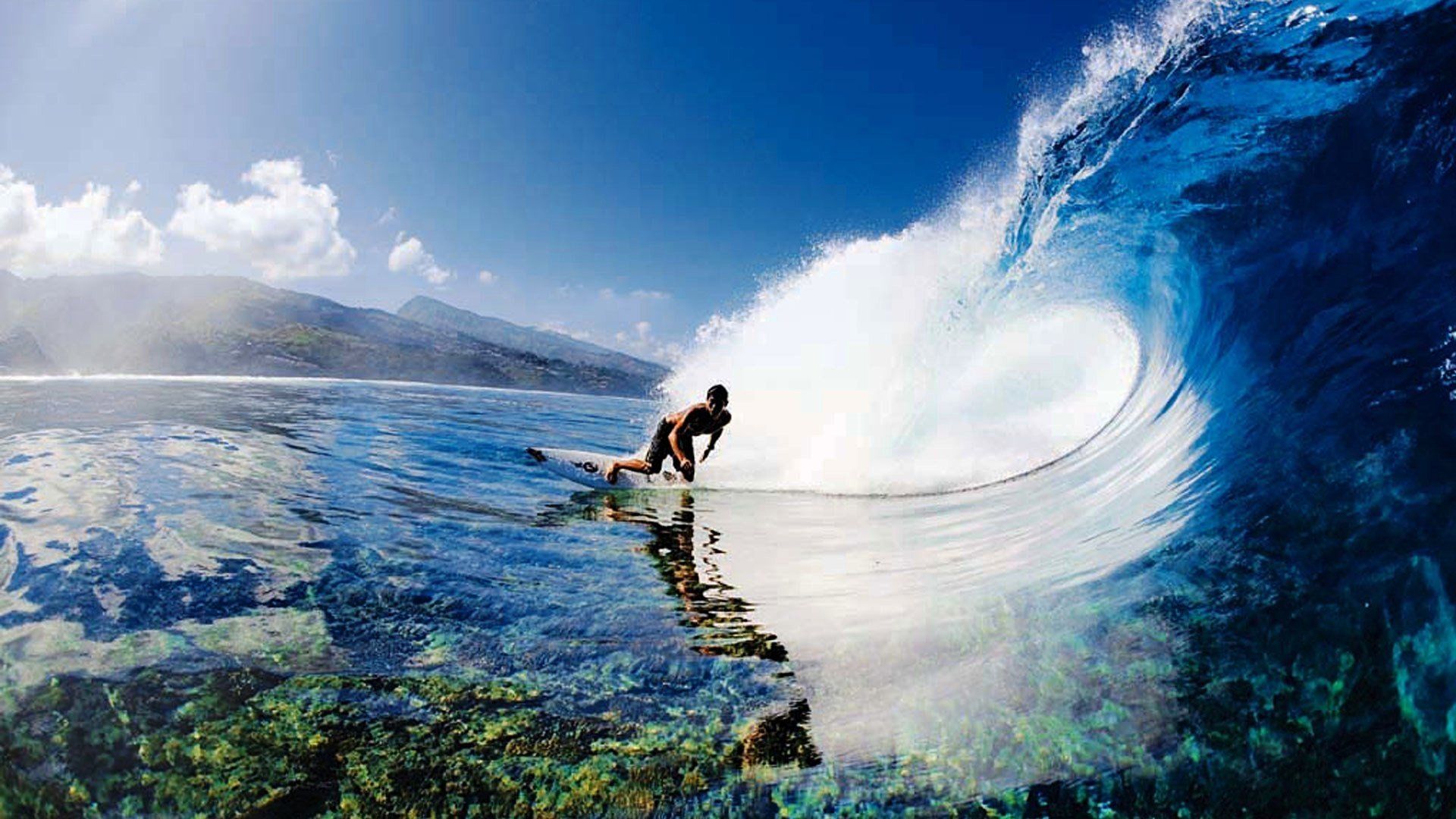 A man riding on top of an ocean wave - Surf