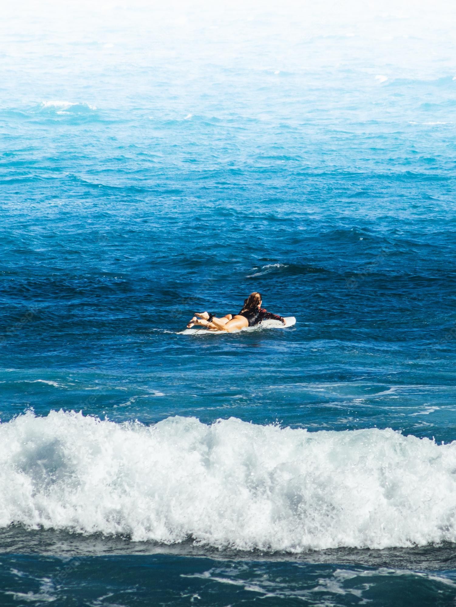 A person on top of water in the ocean - Surf