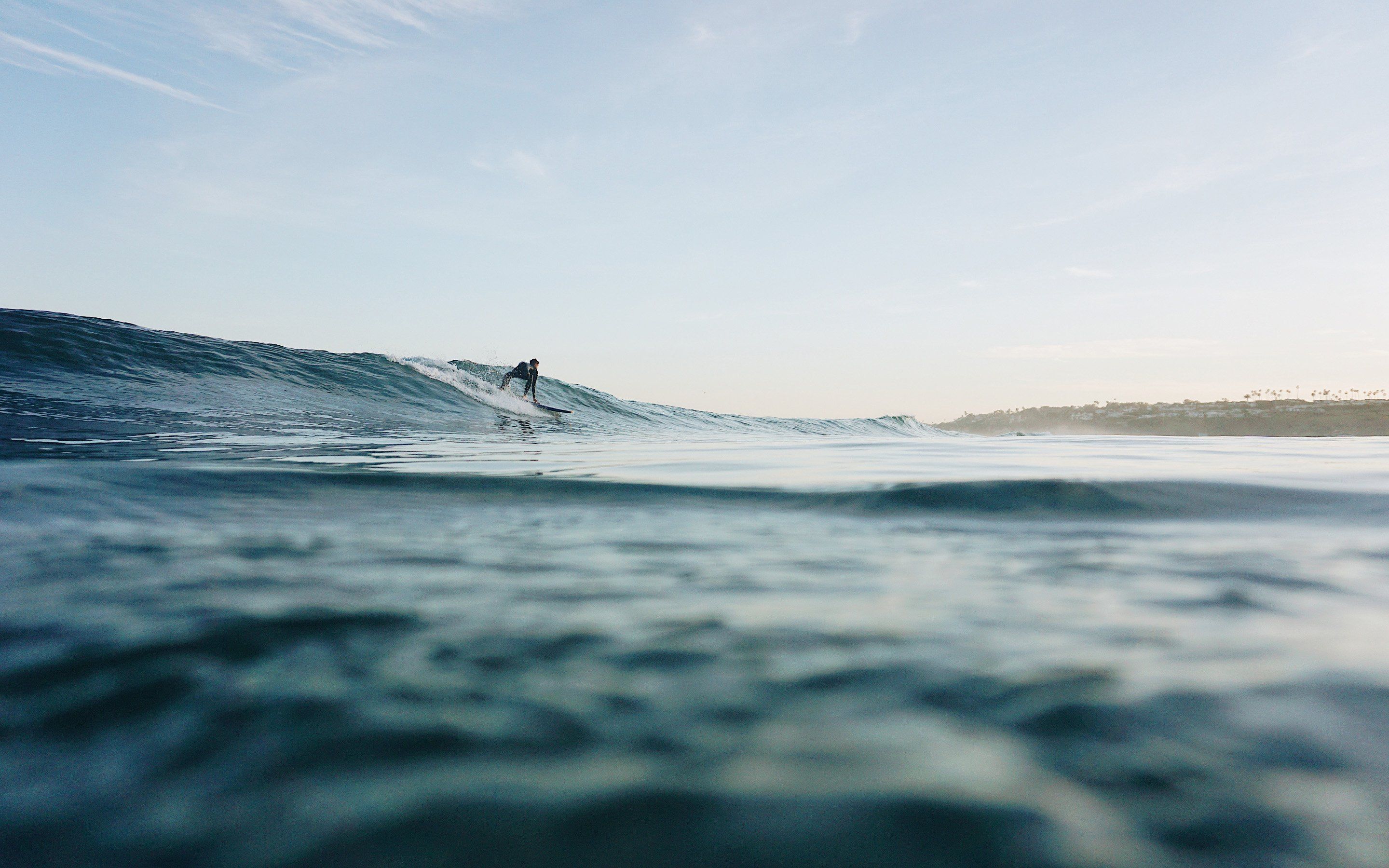 A surfer is riding a wave in the ocean. - Surf