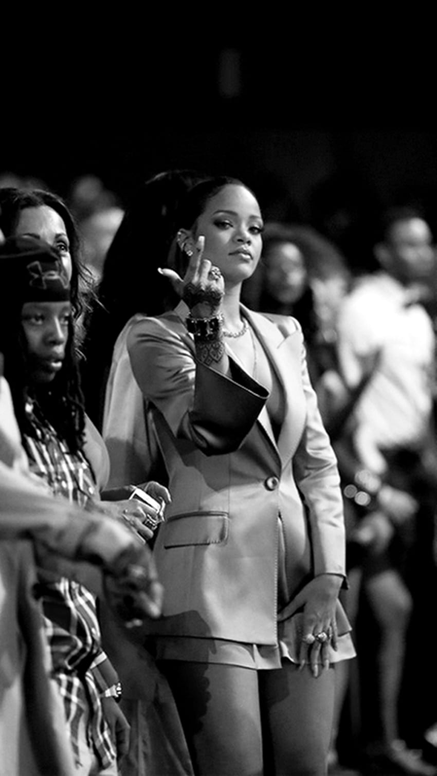 A woman in an outfit is standing on stage - Rihanna