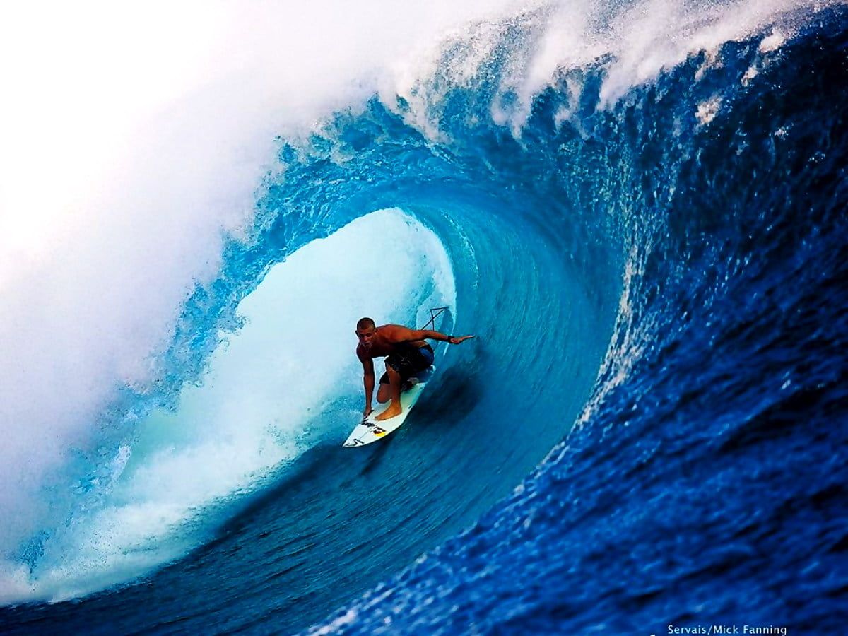 A man riding on top of an ocean wave - Surf