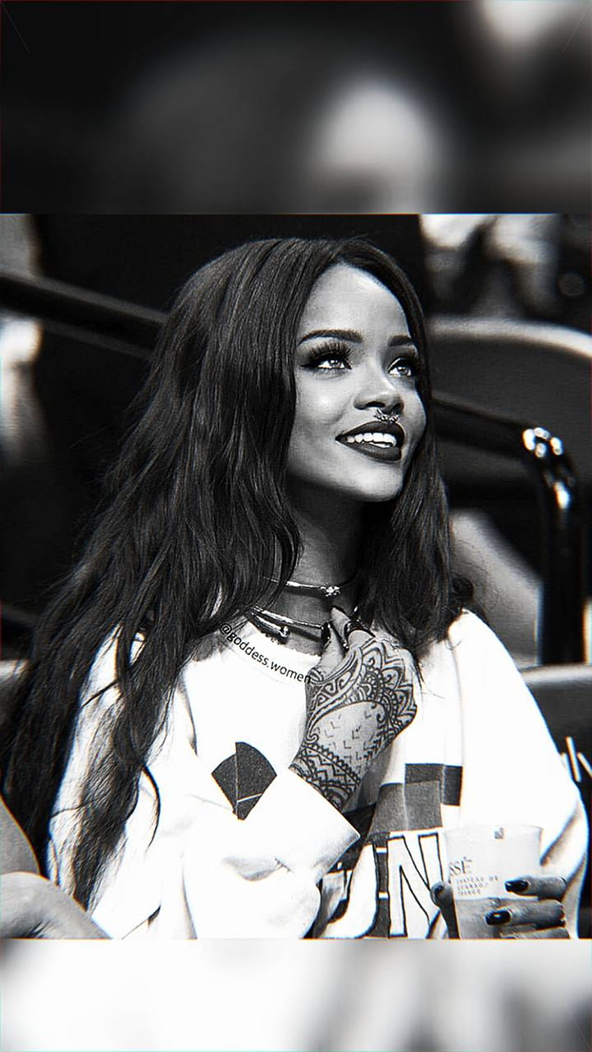 A woman with long hair is smiling - Rihanna