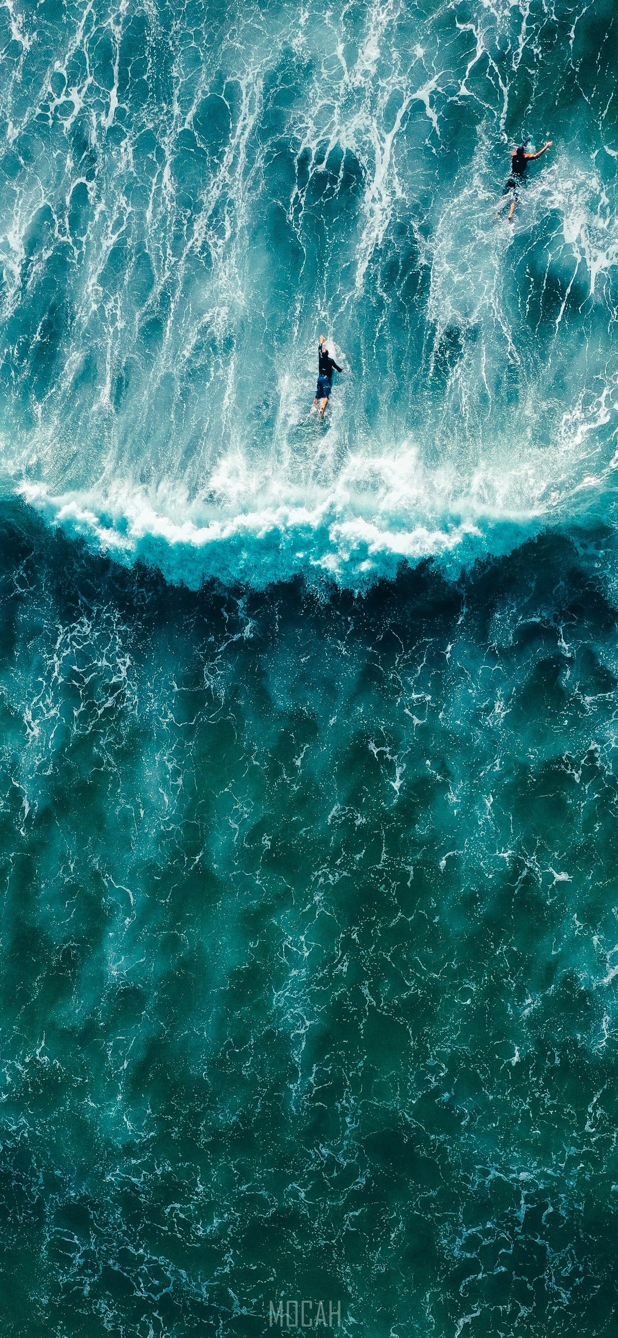 Aerial view of surfers riding a wave - Surf